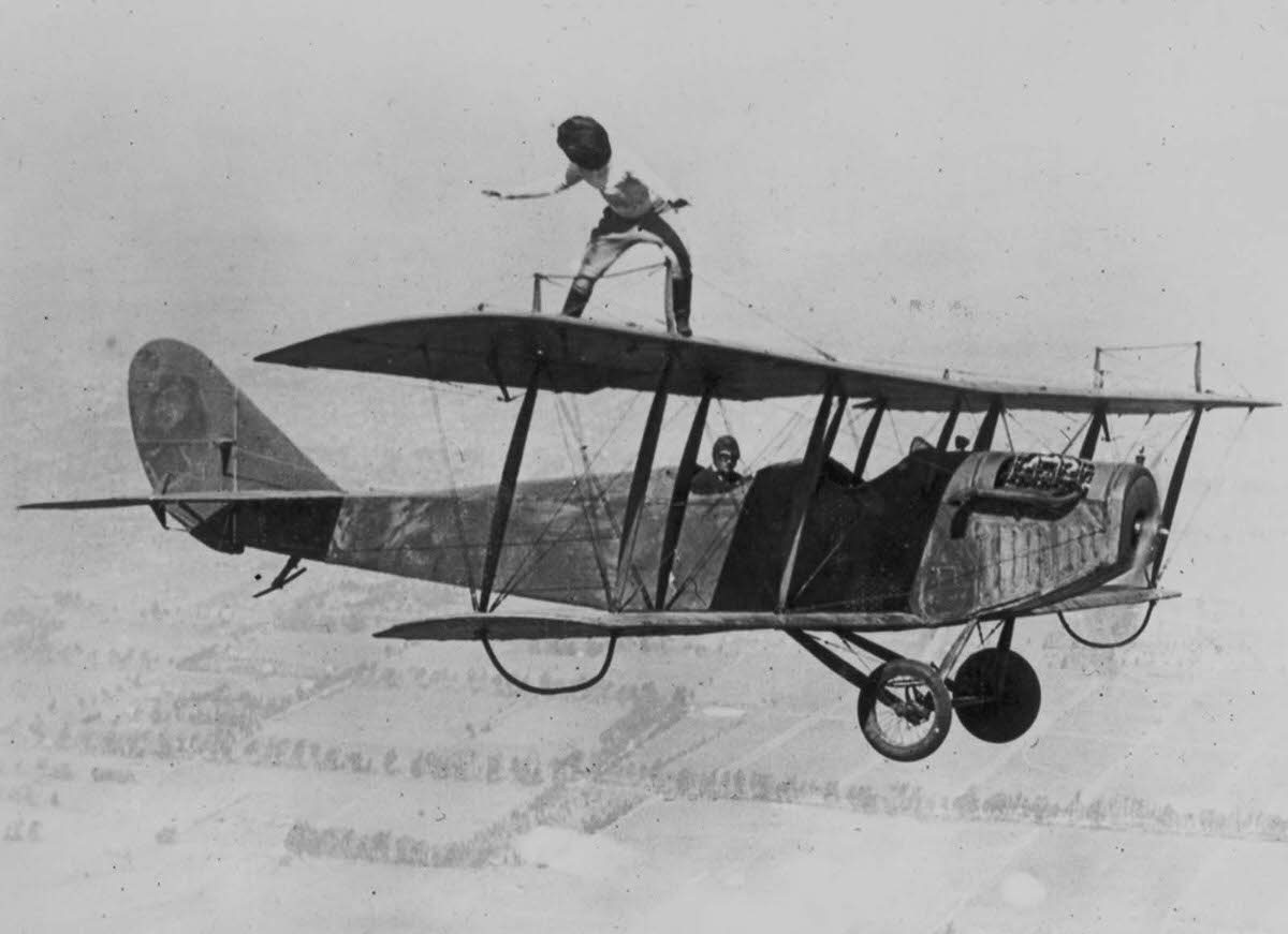 Gladys Roy walks the wings of a Curtiss JN-4 ‘Jenny’ biplane over Los Angeles while blindfolded, 1924.