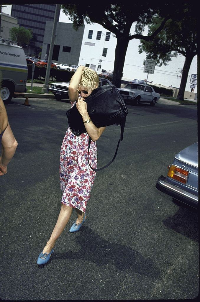 Madonna hiding from a Paparazzi, 1986.