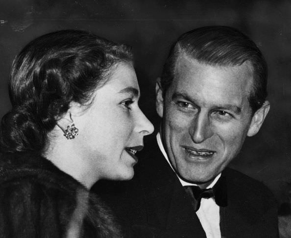 The Queen and Prince Philip talk together in the royal box at a performance of Bertram Mills Circus in London, 1952.