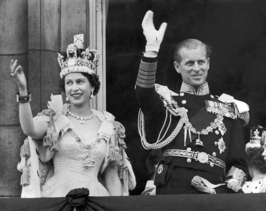 The Queen and Duke of Edinburgh wave from the famous balcony of Buckingham Palace following Elizabeth's coronation, 1953.