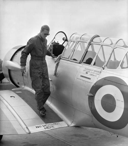 Prince Philip exits a plane after a flight, 1953.
