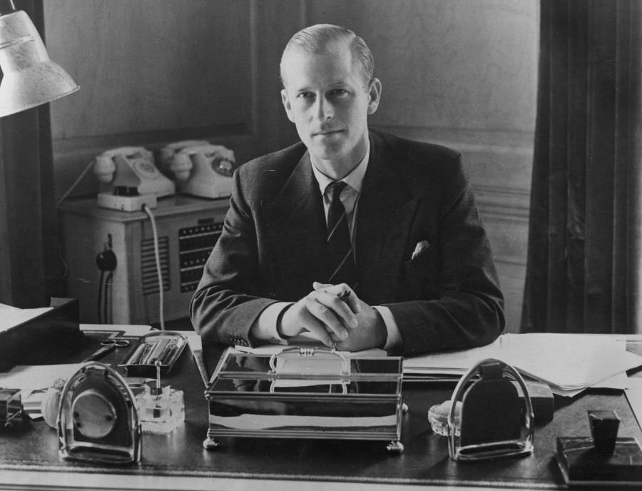 Prince Philip, the Duke of Edinburgh, sitting at his desk at Clarence House, 1951.