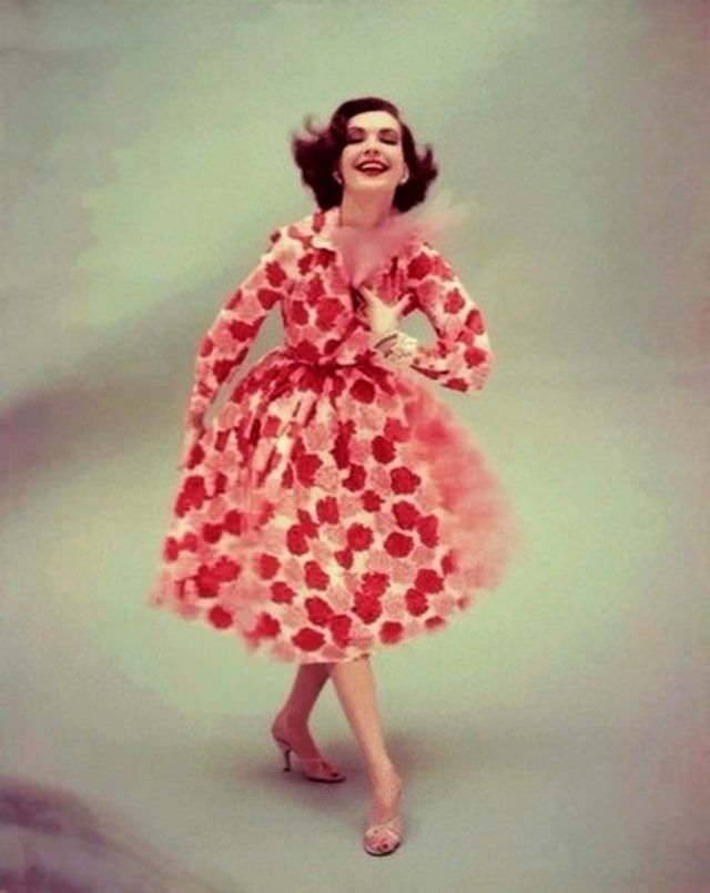 Model is wearing a silk shantung shirt dress, printed with a blur of red and pink carnations, 1955