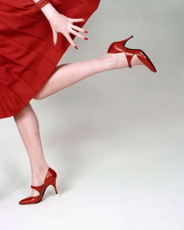 Models legs are running in red glacé lizard shoes by Fleming-Joffe, 1958