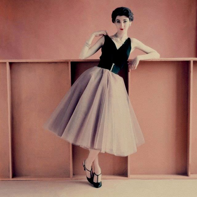 Model is wearing s sleeveless black jersey evening blouse and tulle dancing skirt above a taffeta underskirt, 1952