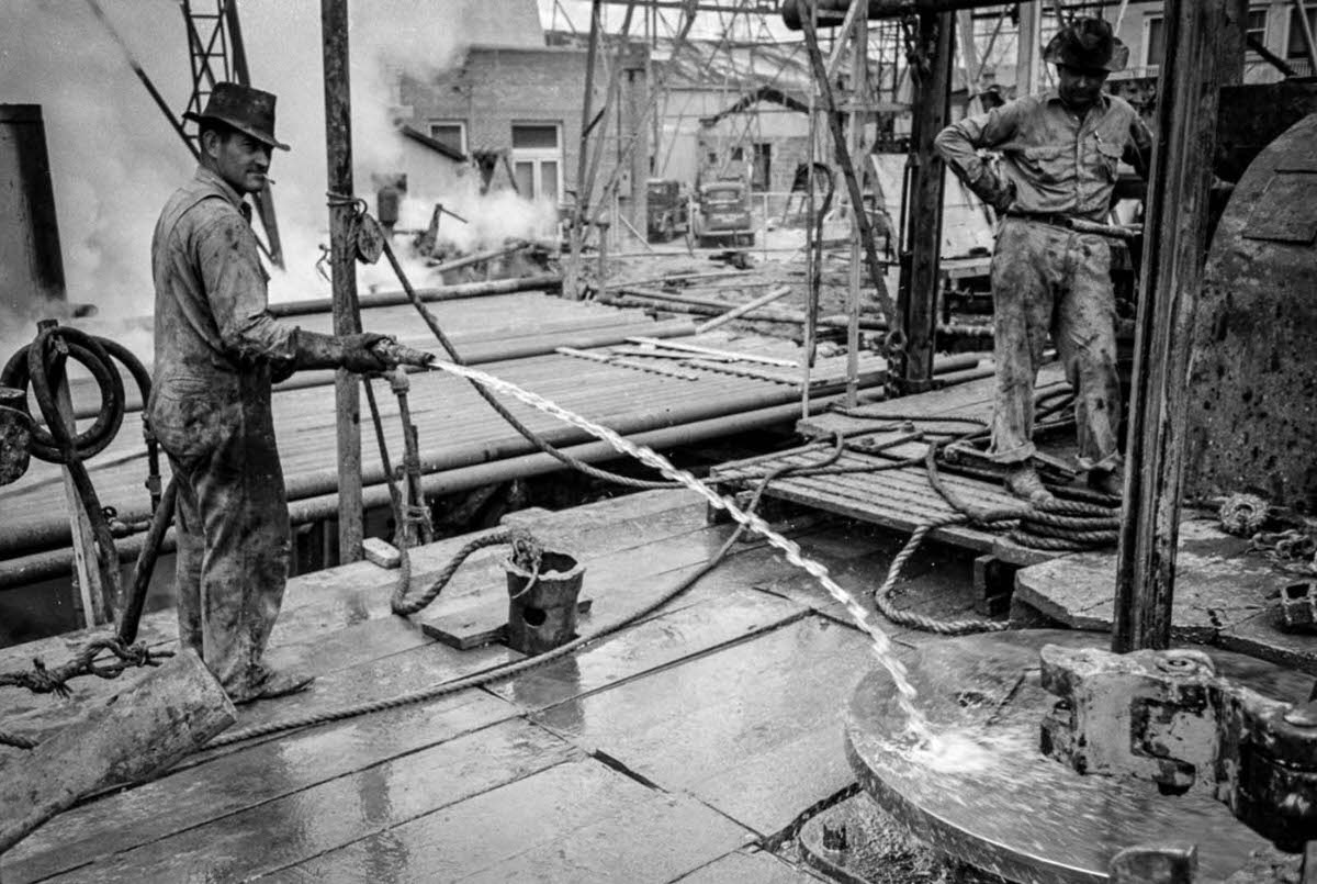 A worker hoses down the rotary table.