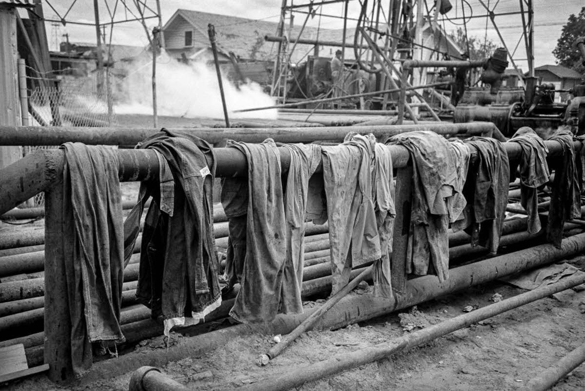 Workers’ clothes dry on a steam pipe.