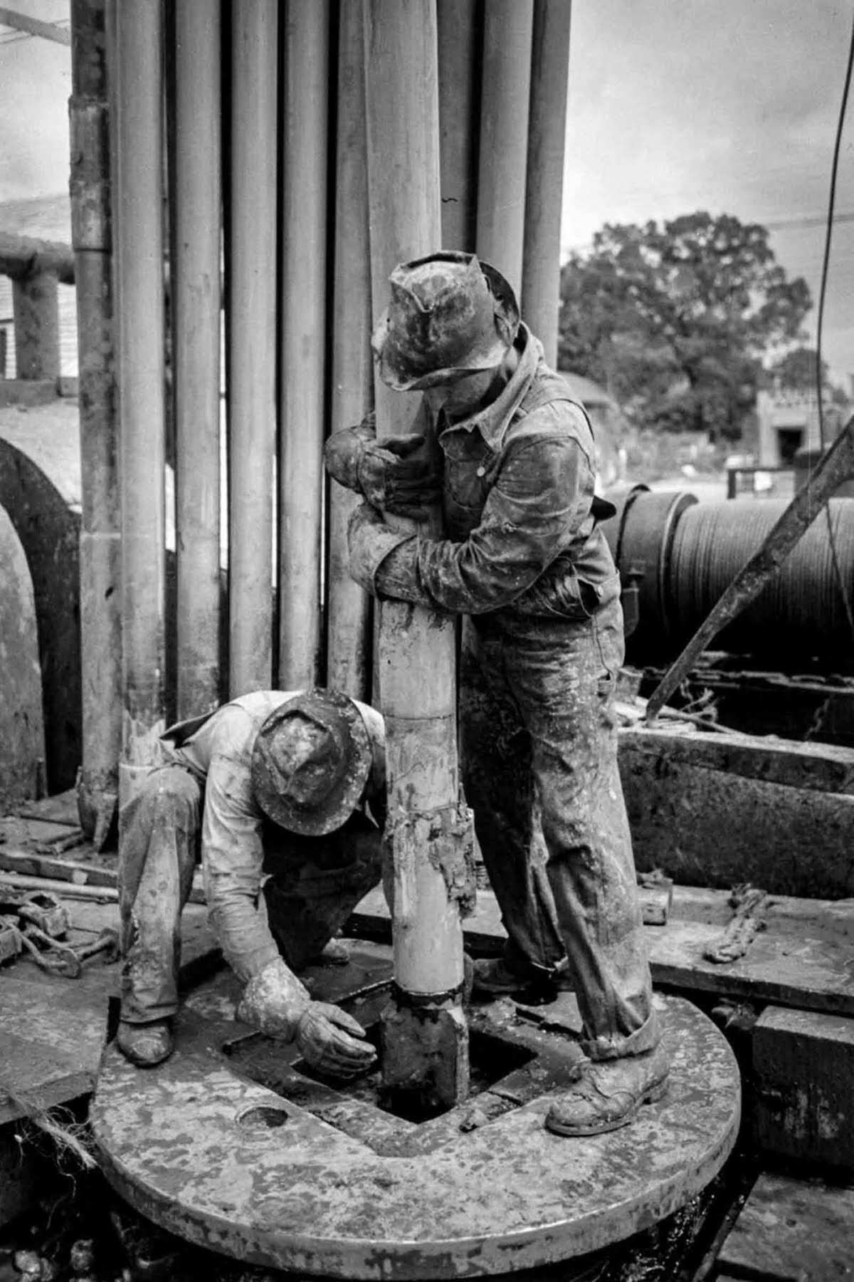 Workers guide the bit through the rotary table.