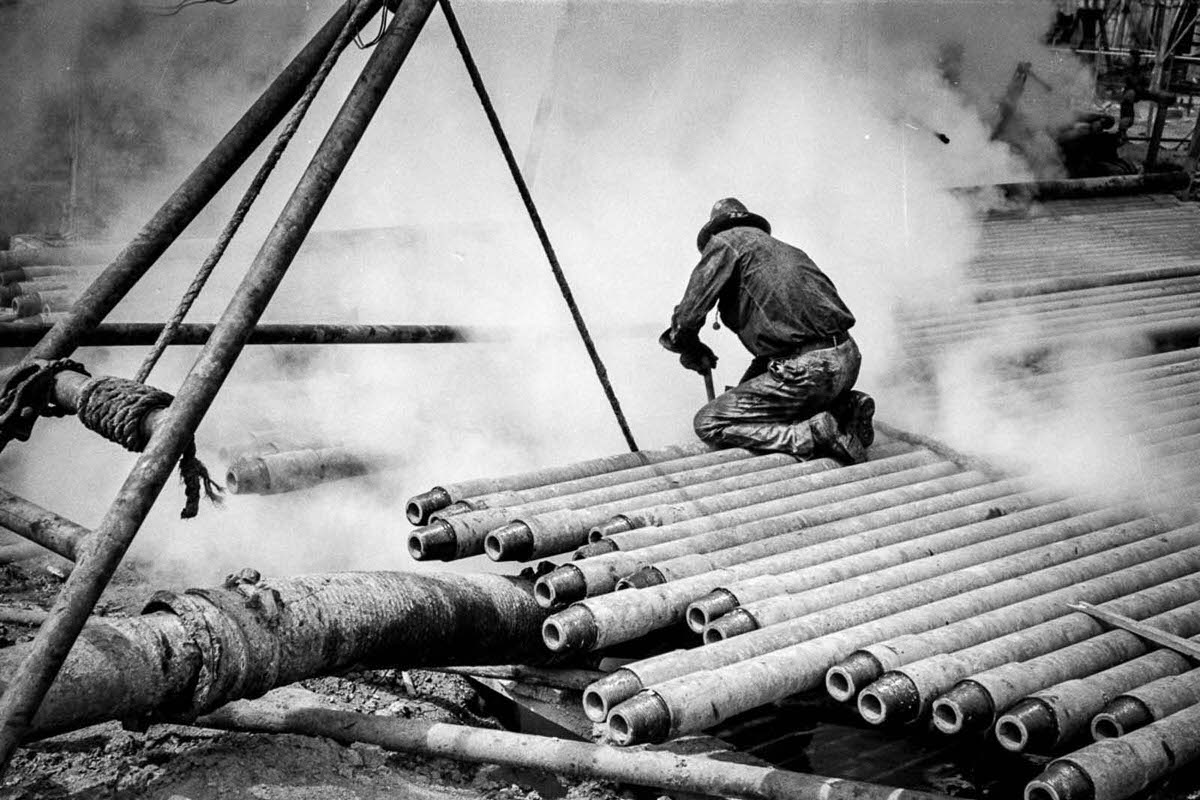 A worker probes in the slush pit.