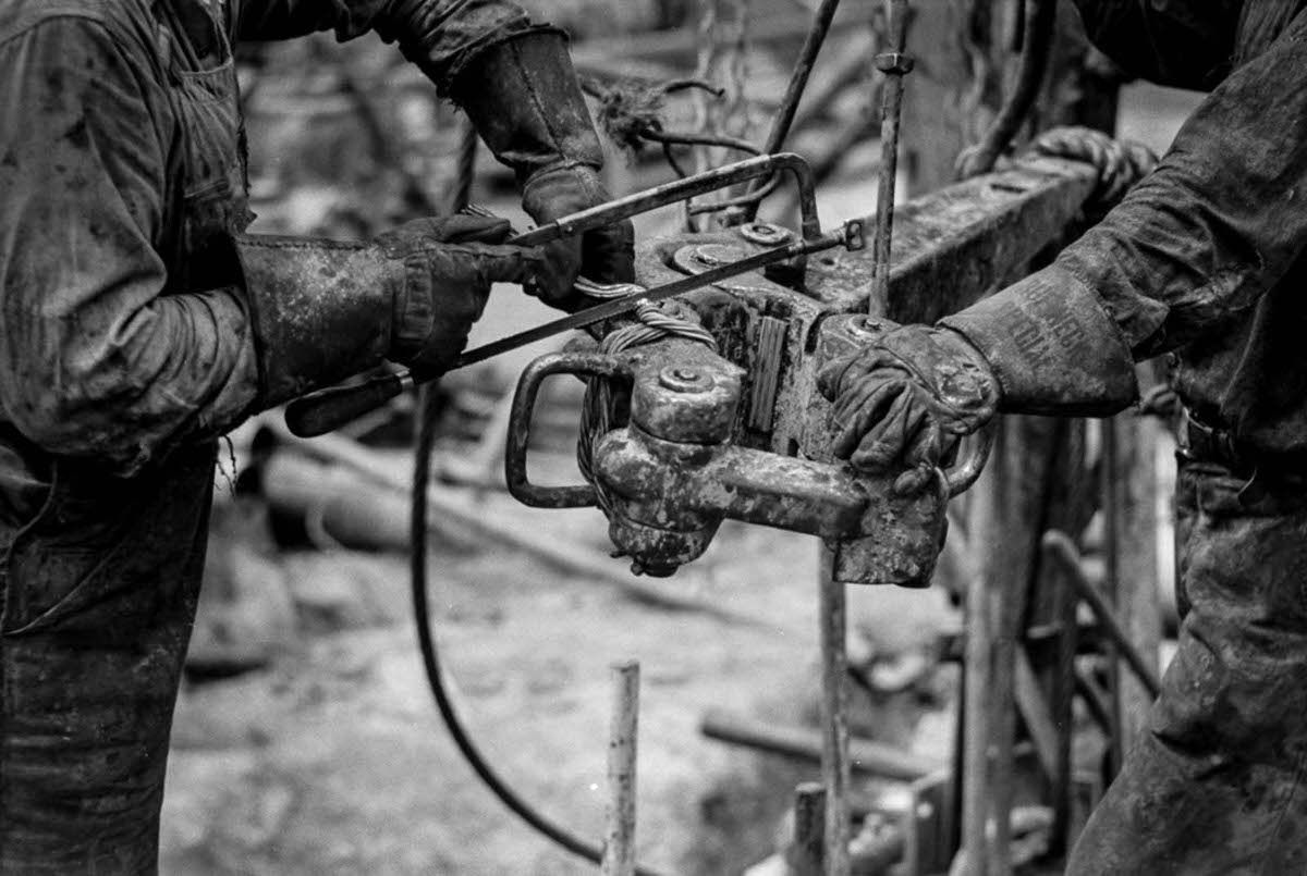 Workers make repairs to a pipe wrench.