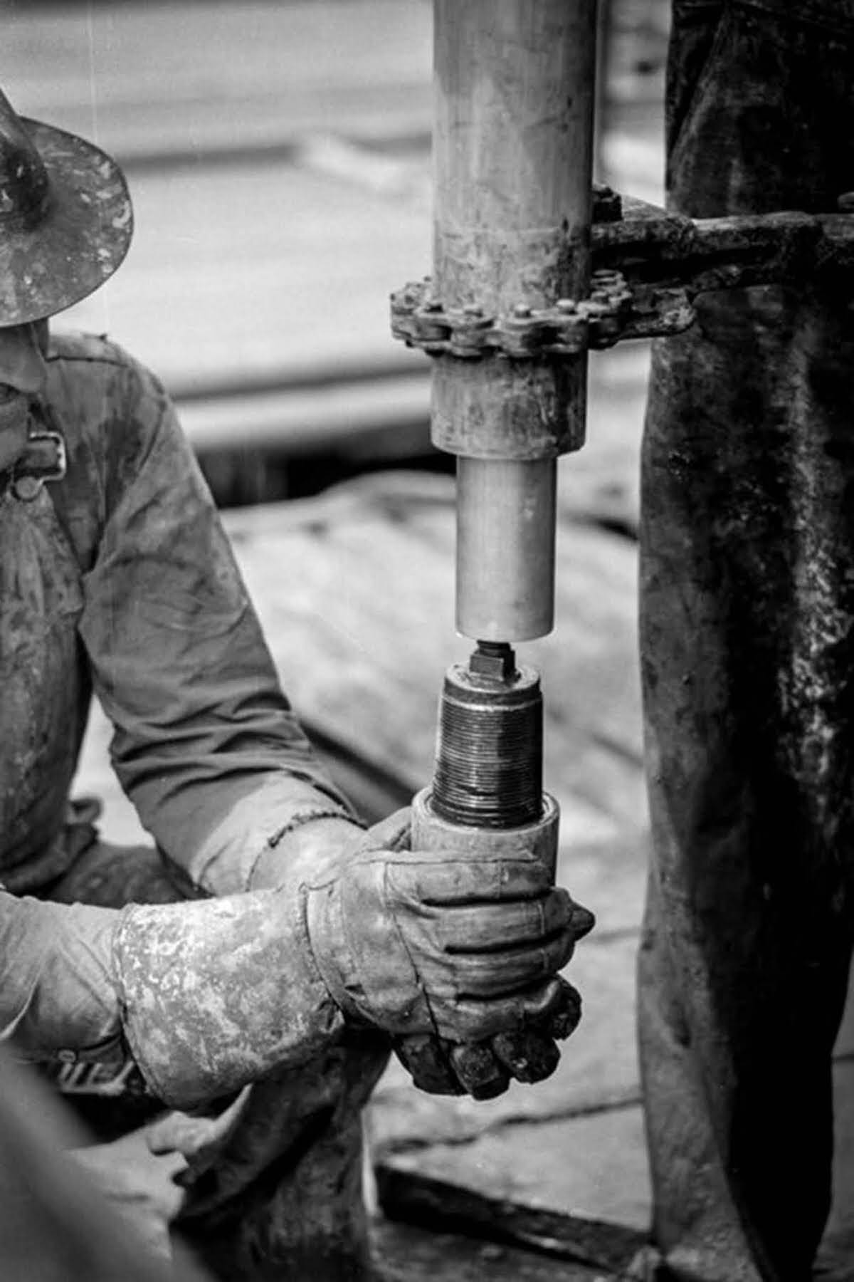 A worker screws on a nipple.