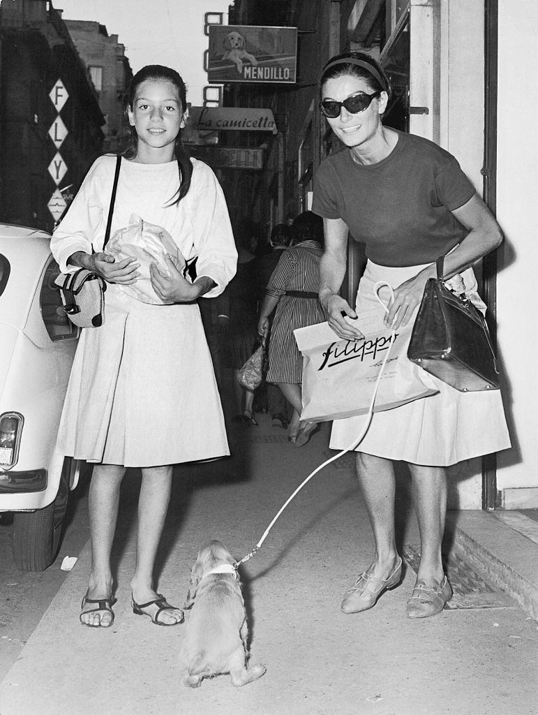 Anouk Aimée with her puppy and a girl, 1980s.