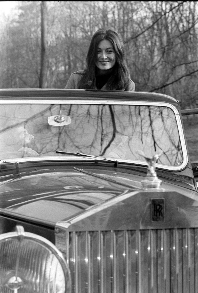 Anouk Aimee riding an automobile, France, 1967.