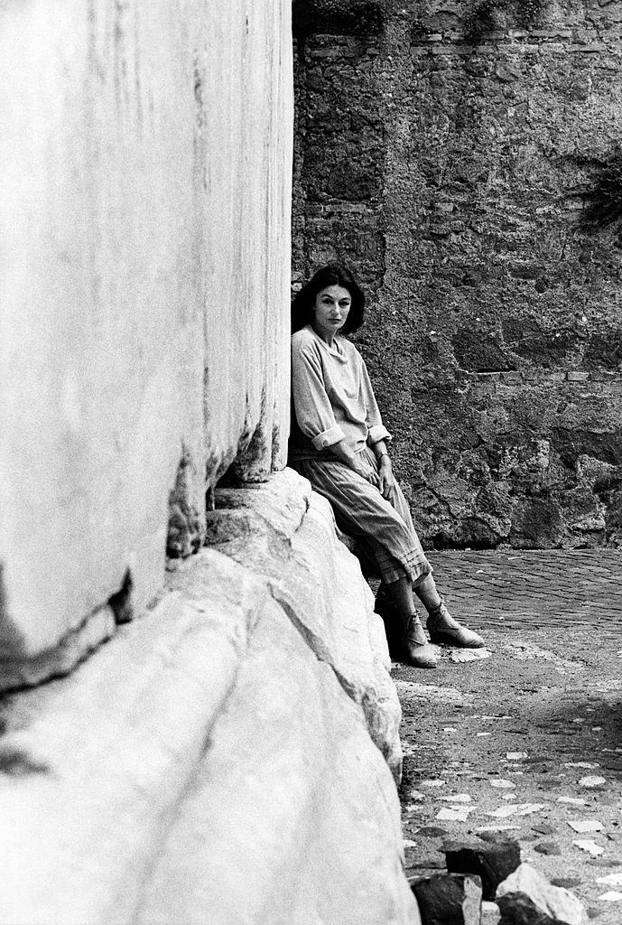 Anouk Aimée, born Françoise Sorya Dreyfuss, poses against a column in the Roman ancient zone., 1975.