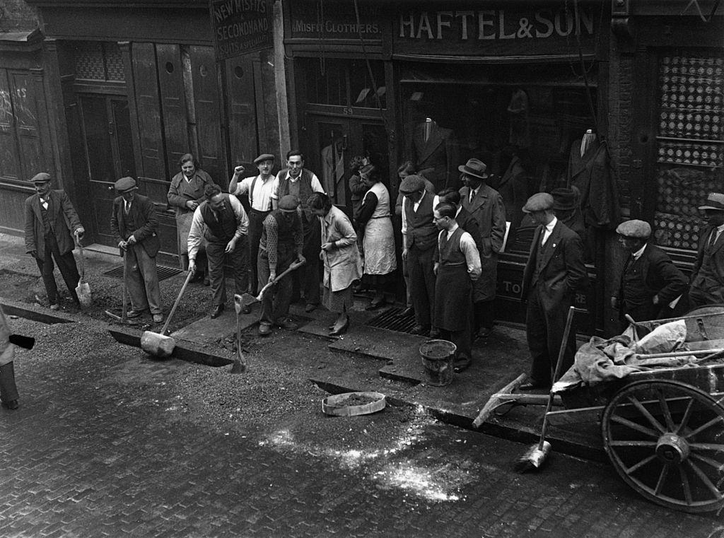 Repairing a pavement in Cable Street, Mark Lane, London which was ripped up to prevent a Fascist march.