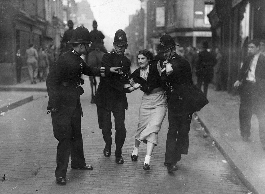 Policemen arresting a demonstrator when fascists and communists clashed during a march know as the Battle of Cable Street, 1936.