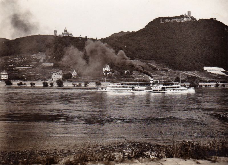 An ancient paddle Steamer pushing upstream past Drachenburg Castle and Drachenfels on the River Rhine near Bonn, 1930