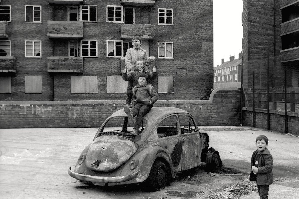 4 boys on a VW Beetle, Vauxhall Road area, Liverpool, 1980s