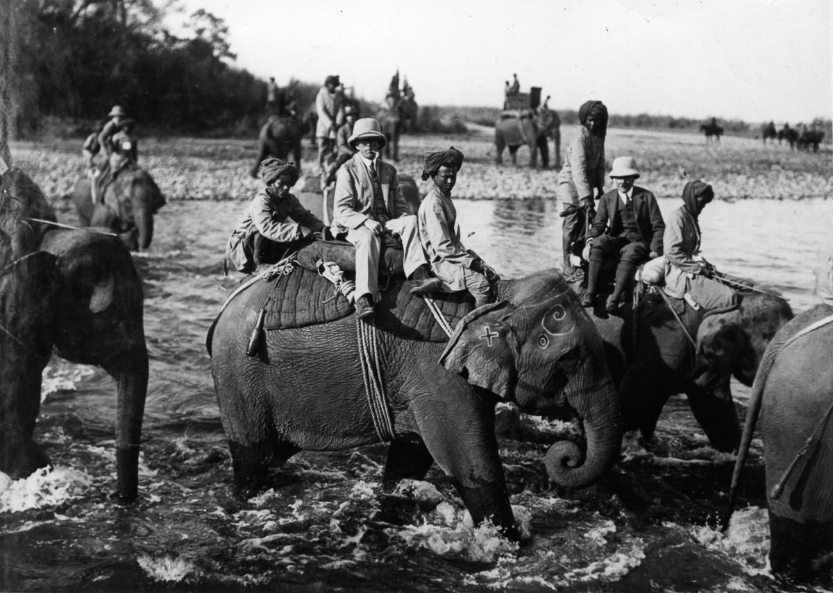 The hunting party crosses a river.