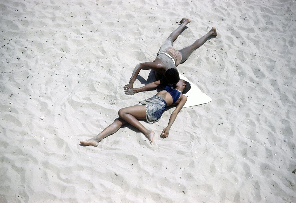 An African American couple canoodle on Coney Island beach, 1948.