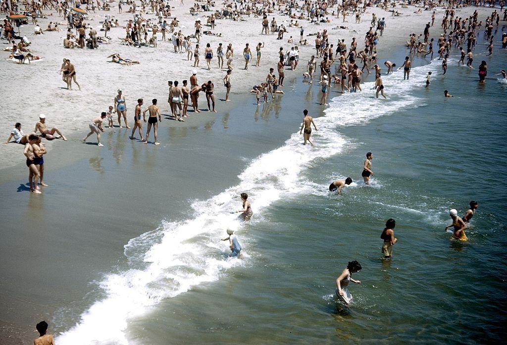 Sunbathers and swimmers on Coney Island beach, 1948.