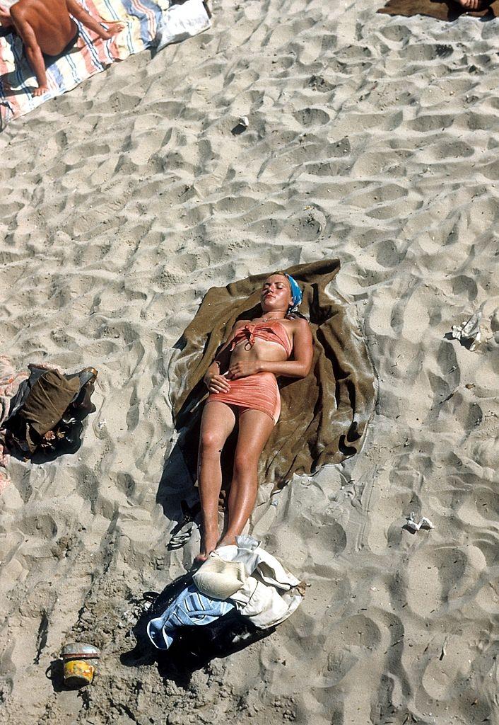 A woman sunbathes on Coney Island beach, 1948.