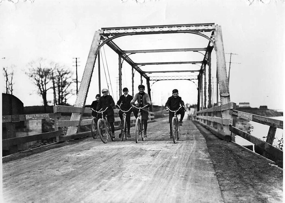 Boys cycling across Lakeshore Road bridge at Mimico, 1907