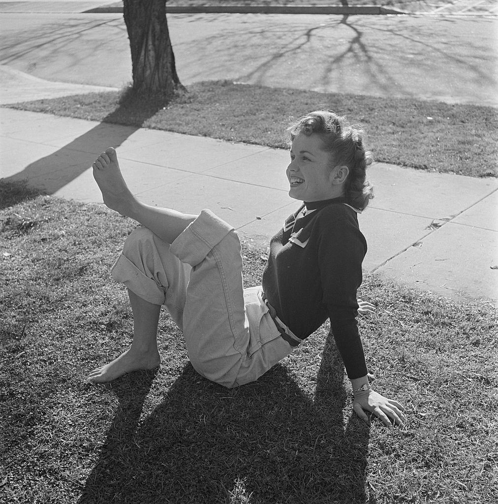 Debbie Reynolds posing on the grass, 1950.