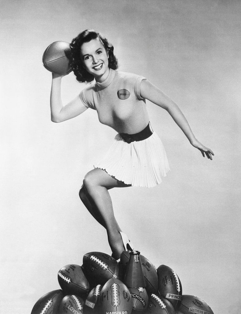 Debbie Reynolds gets ready to throw a pass to kick off the football season, 1953.