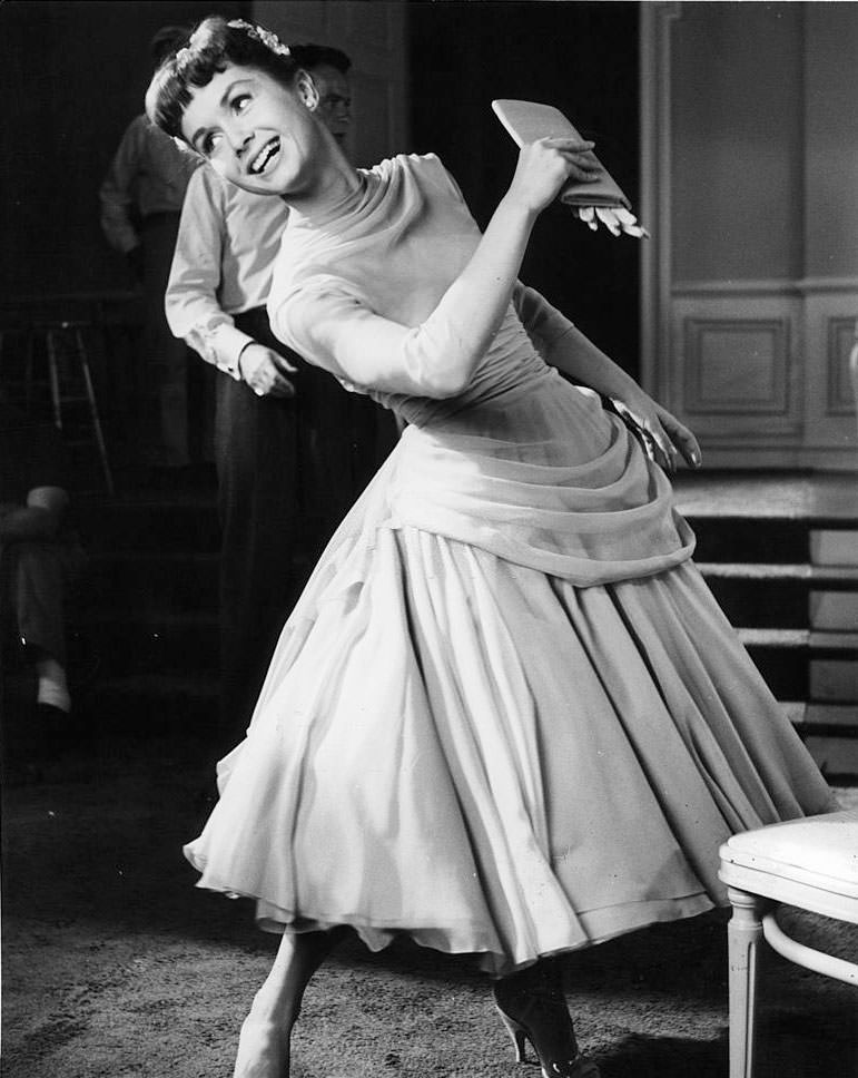 Debbie Reynolds leaning and looking back in a scene from the film 'The Tender Trap', 1955.