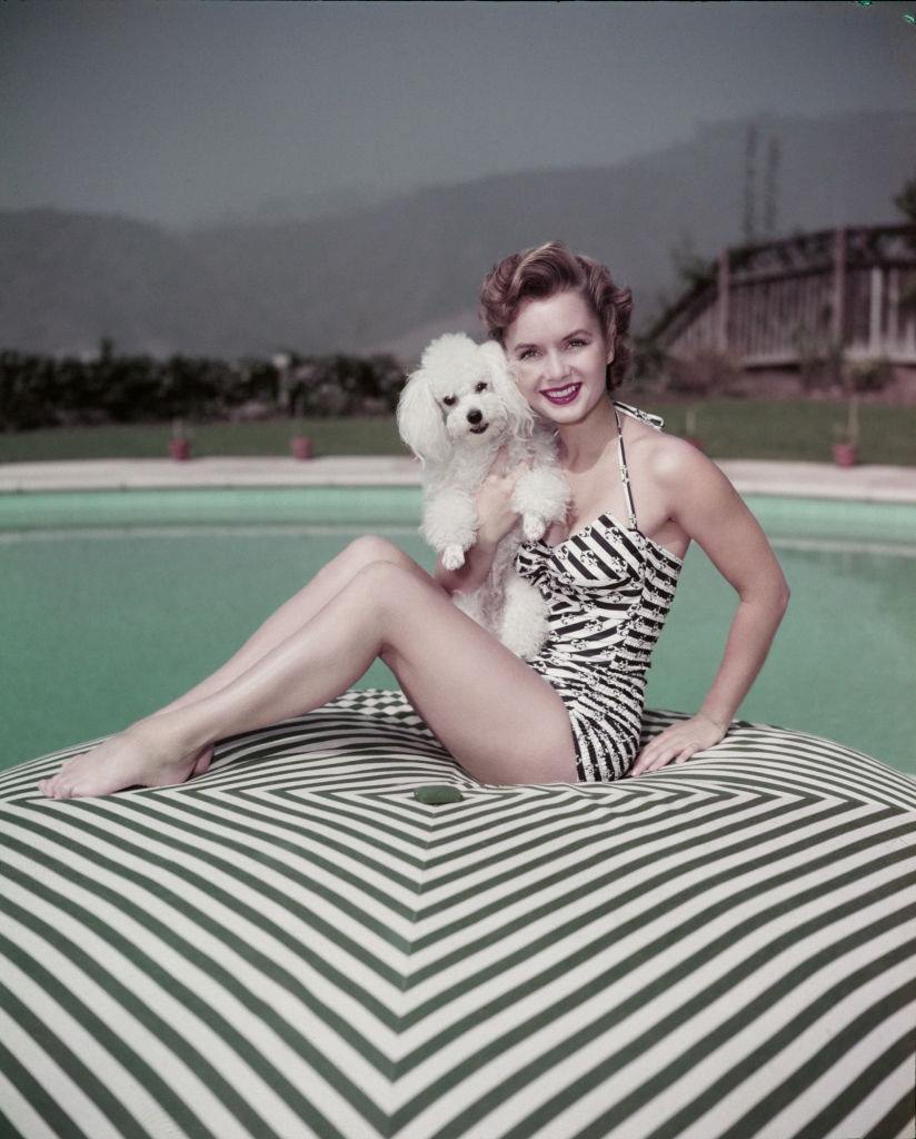 Debbie Reynolds holding a dog, 1955.