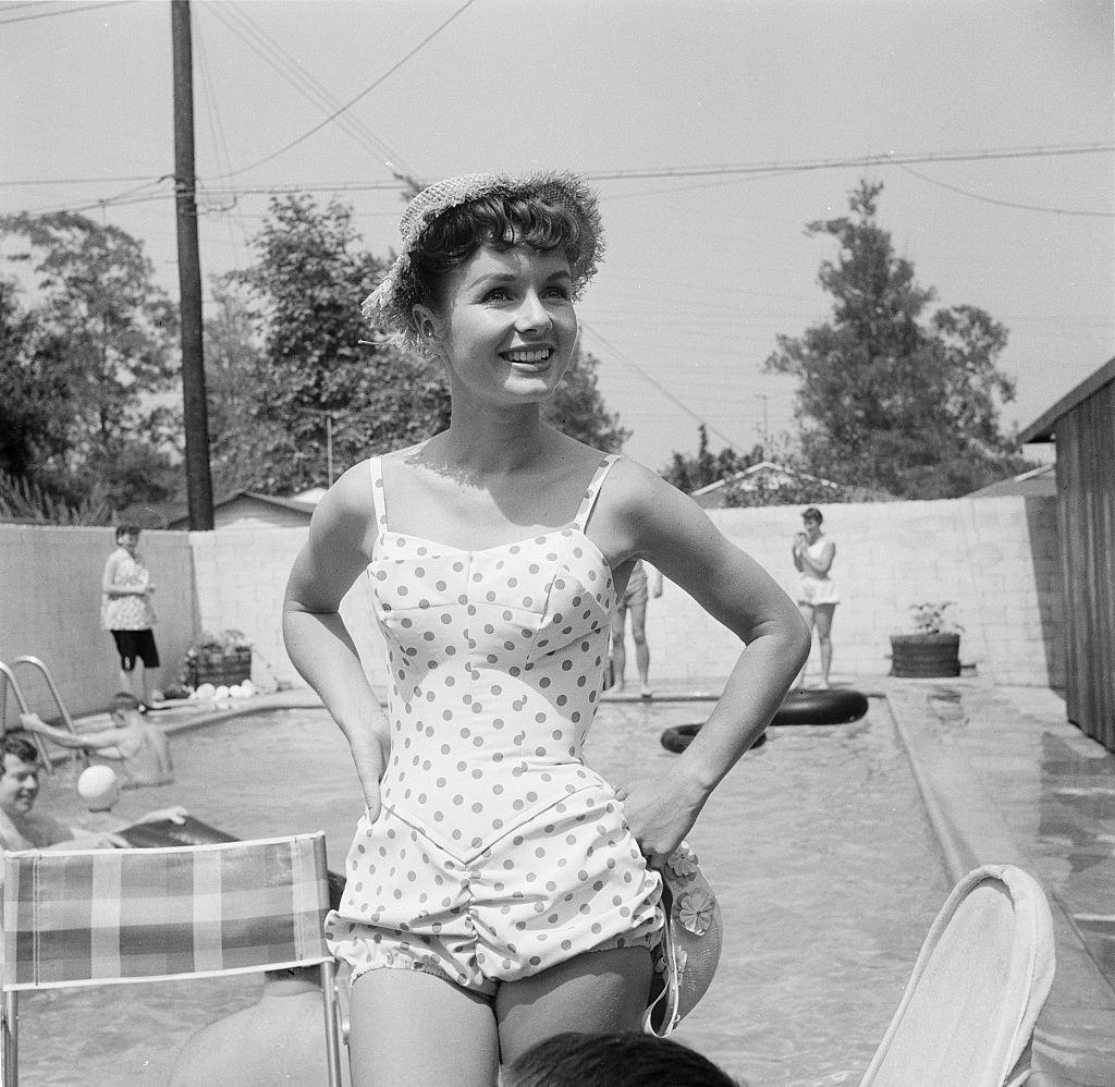 Debbie Reynolds entertains guest at her pool party, 1955.