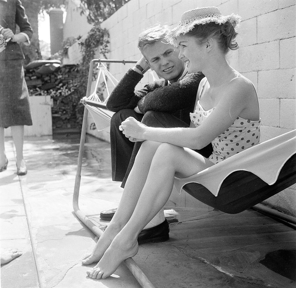 Debbie Reynolds with John Ericson at her pool party in Los Angeles, 1955.