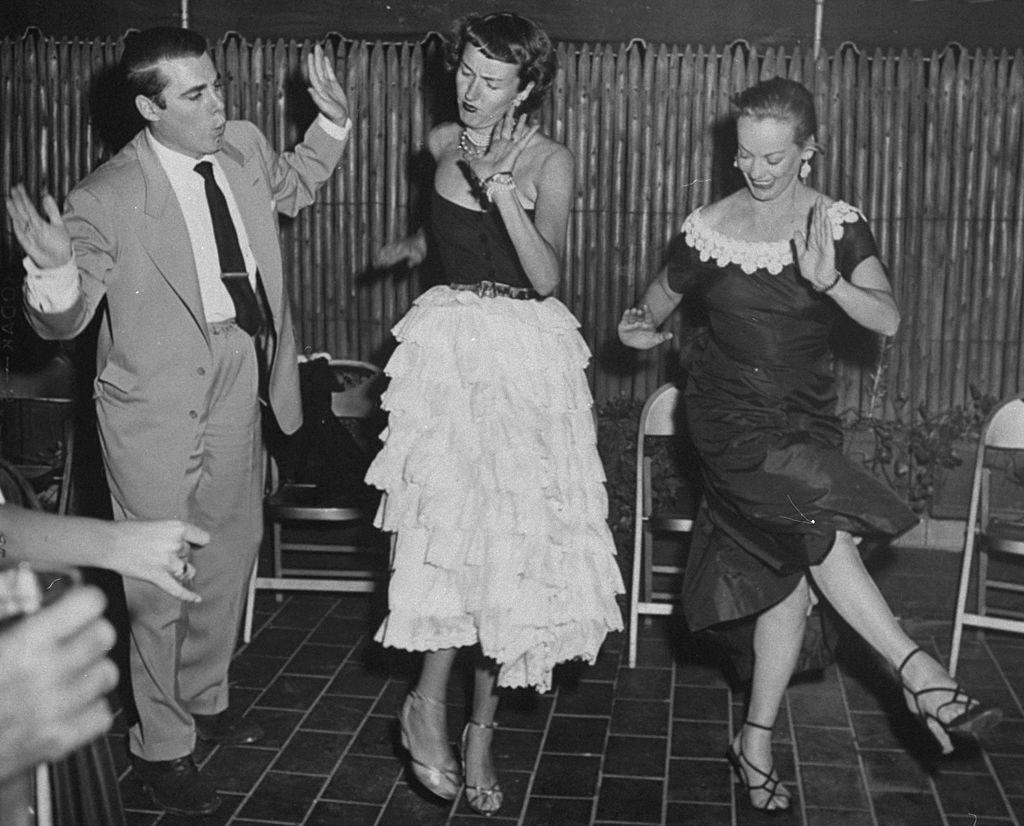 Faye Emerson with Pete Brandon and actress Sally Kirkland in the Charleston at party on E. 73rd St, 1950.