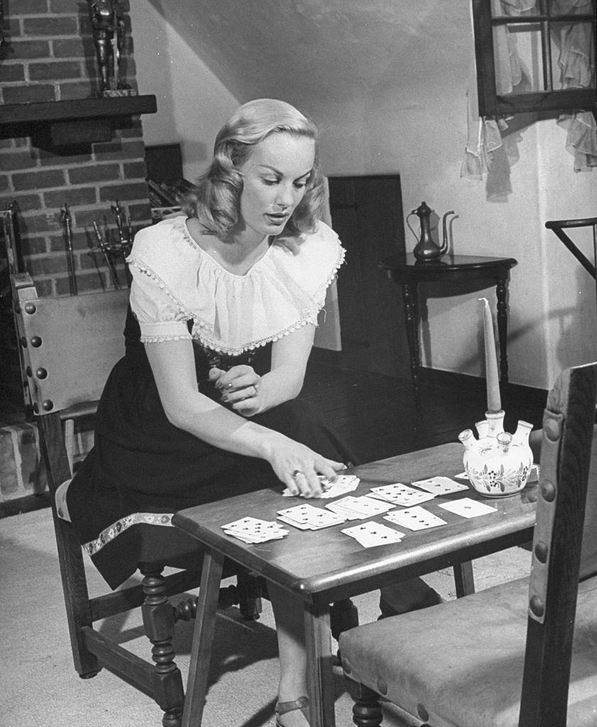 Faye Emerson playing solitaire at home, 1945.