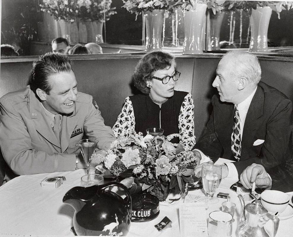 Faye Emerson with Elliott Roosevelt and Walter Winchell Sitting at Table, 1945.