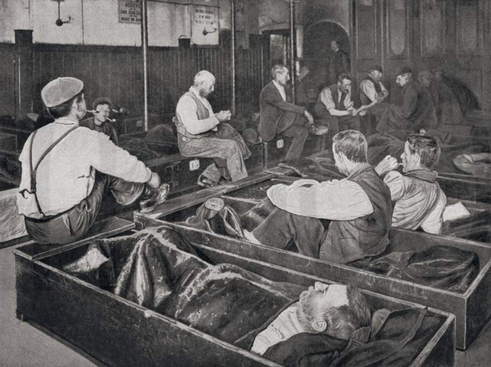 Men at the four penny coffin, aka coffin house, ca. 1901.