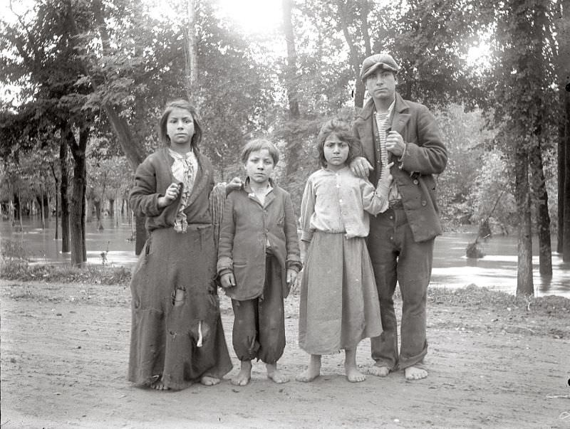 Man and children in rags with bare feet, circa 1910