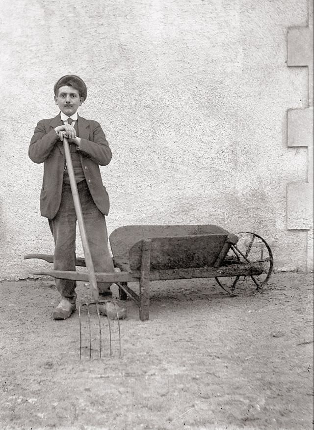 Roger Pierron with fork and wheelbarrow, taken near La Féolle, December 15, 1918