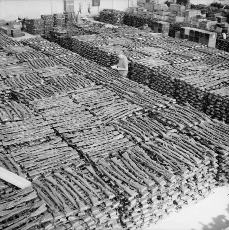 Storeroom at Solar aerodrome, Stavanger, holding some of the estimated 30,000 rifles taken from German forces in Norway after their surrender.