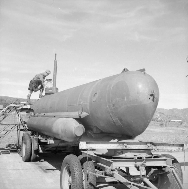 An officer of a Highland regiment inspects a German Molch (Salamander) one-man submarine at Solar aerodrome, Stavanger, Norway.