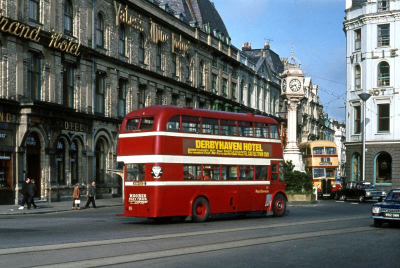 Road Sers No.85, a 1950 built Leyland PD2 passes the Clock Tower on the prom at Douglas with Corpn Regent No.71 just appearing, 2 July 1971