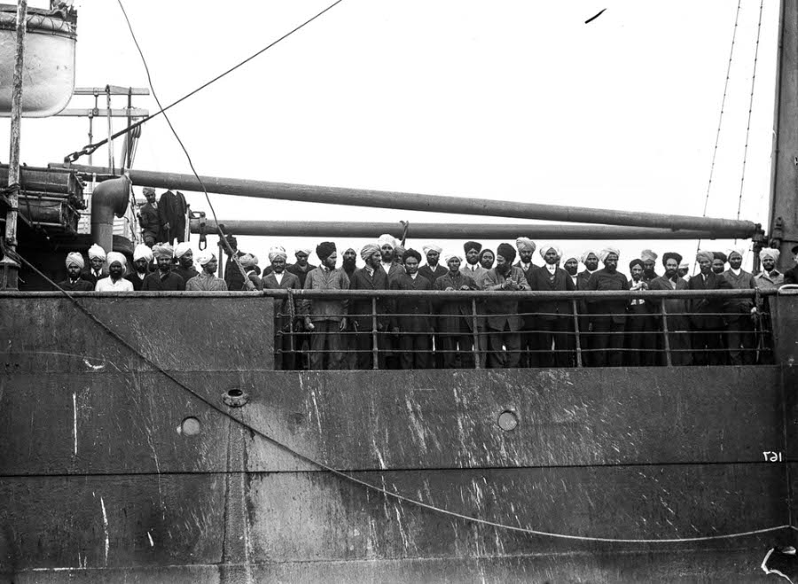 Passengers wait on the Komagata Maru off the shores of Vancouver.