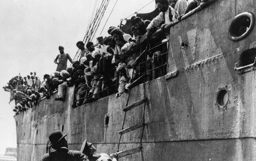 Passengers reach out as immigration officials board the Komagata Maru.