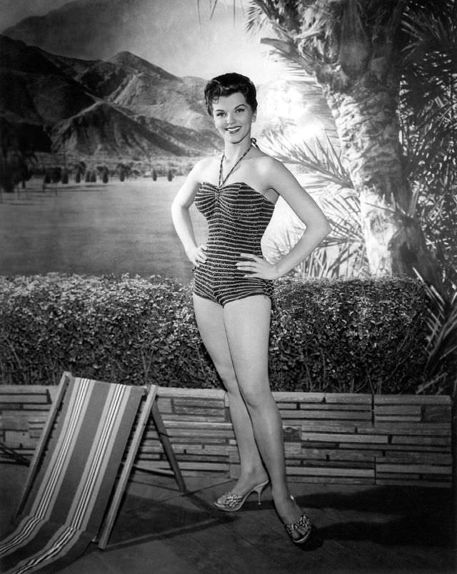 Lisa Gaye posing by a tree, 1950s.