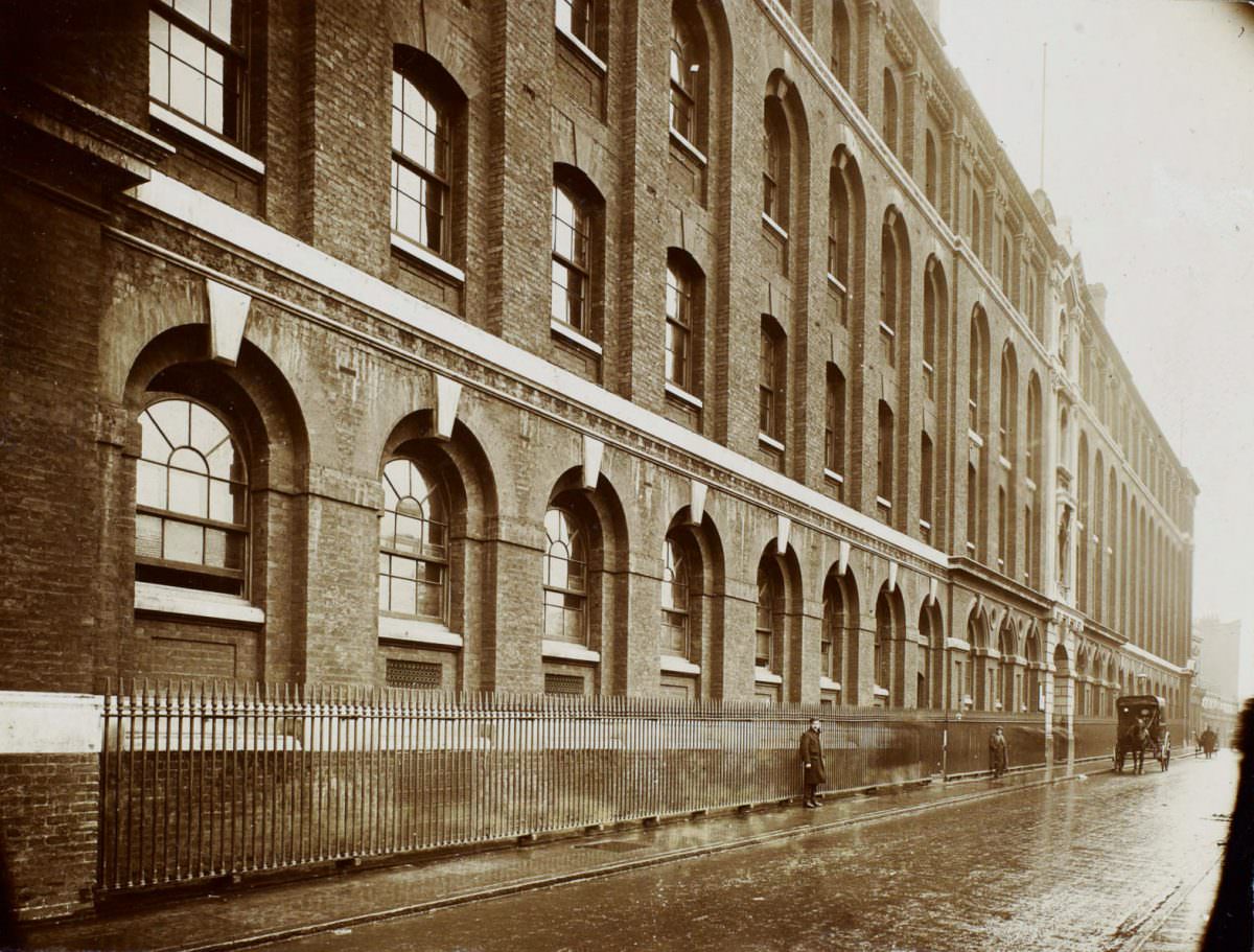 Whitechapel Infirmary -Wide view along the front of a long, four-story building with arched windows on the first floor.