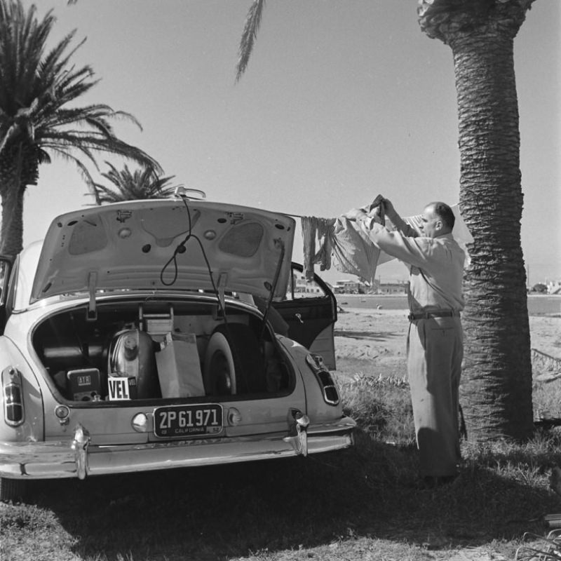 Louis Mattar hangs washing from his heavily modified 1947 Cadillac.
