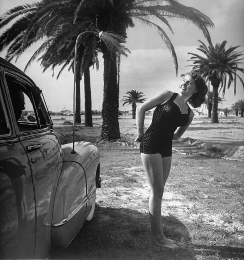 Jackie Smithwick, friend of the Mattars’, takes a warm water shower next to front fender.