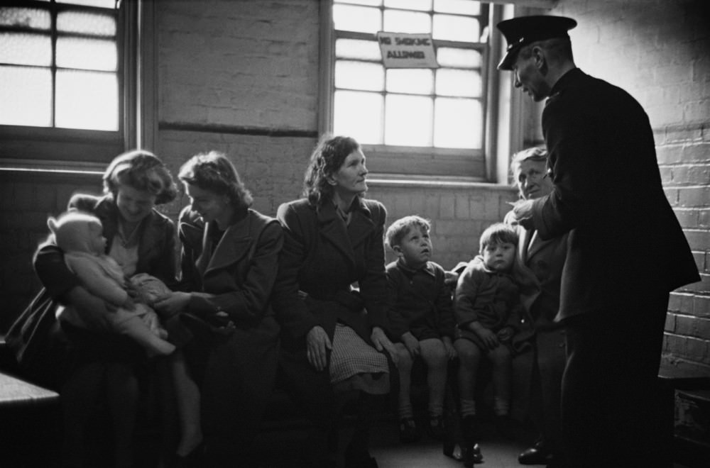 Prison officer Davidson talks to a group of visitors at Strangeways Prison.