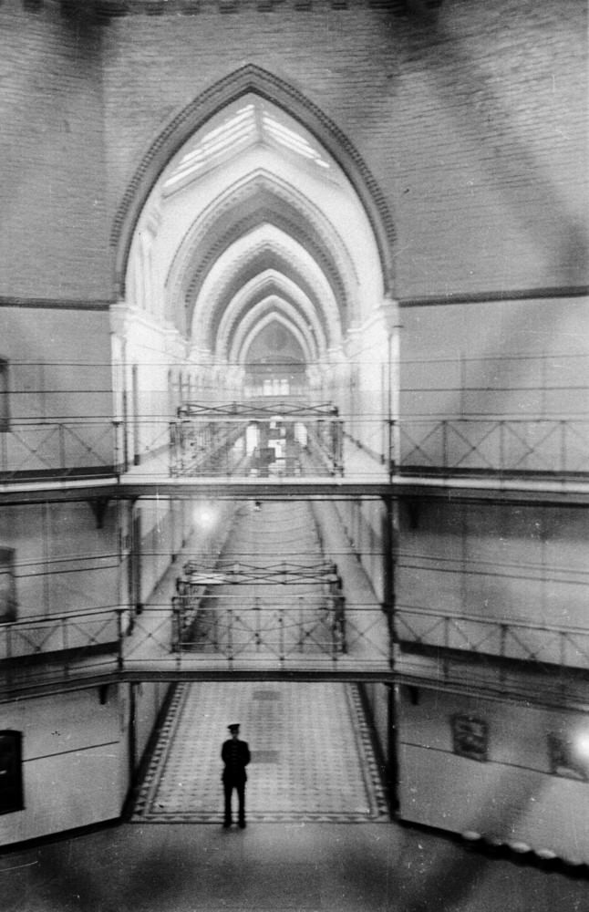 A prison officer surveys his dominion at 6.30 in the morning shortly before the wake-up bell at Strangeways Prison.